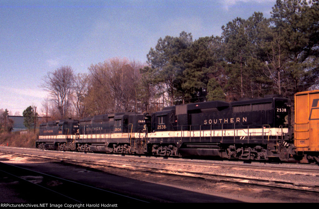 A trio of GP30's leads a train thru the yard